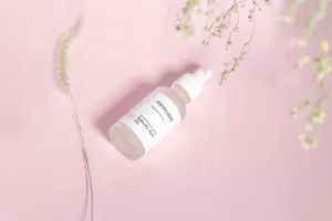 a skincare Product photoshoot with minimal theme and pink background.